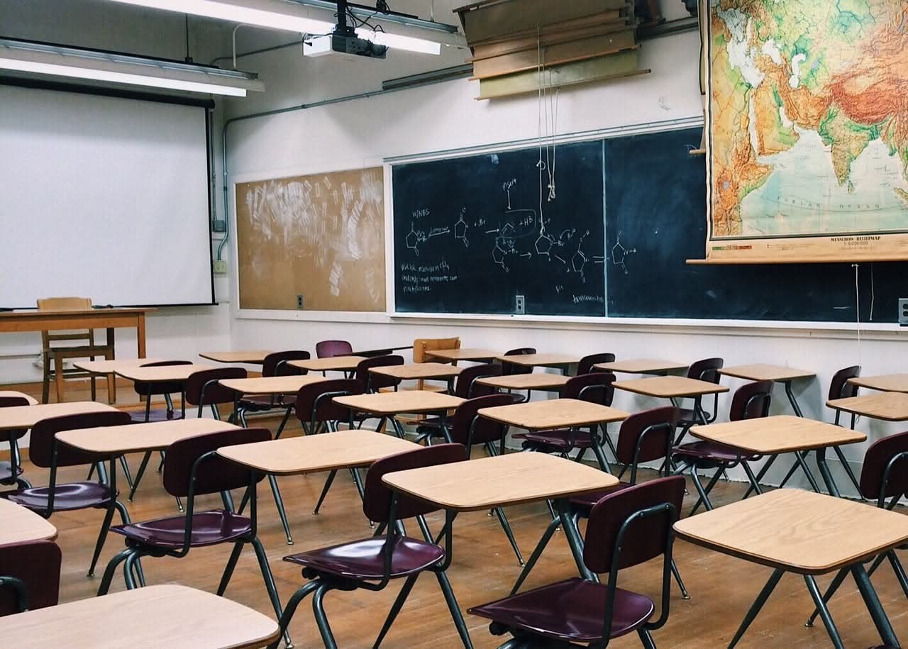 a classroom with a chalkboard showing chemistry