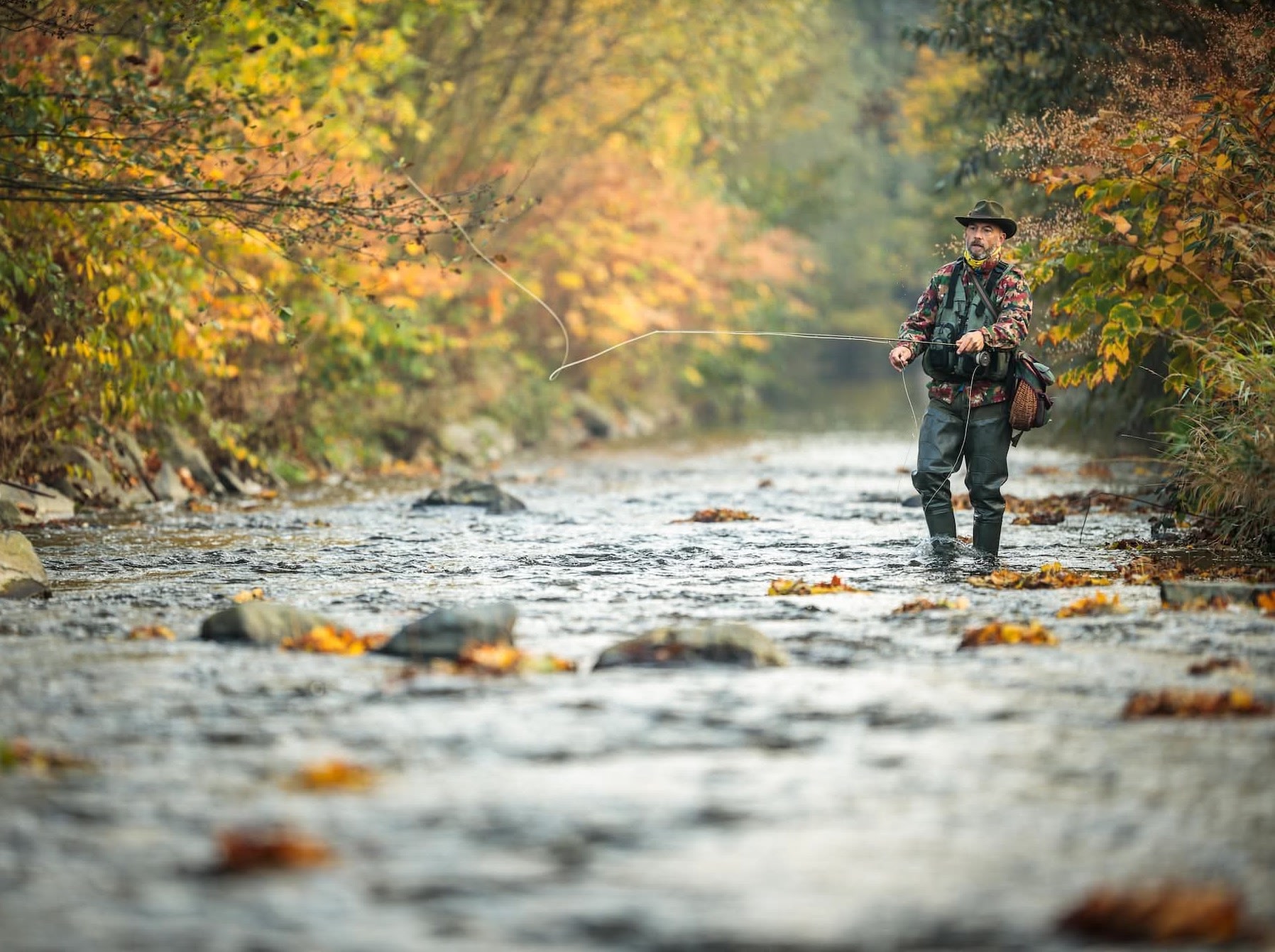 man fly fishing in a stream